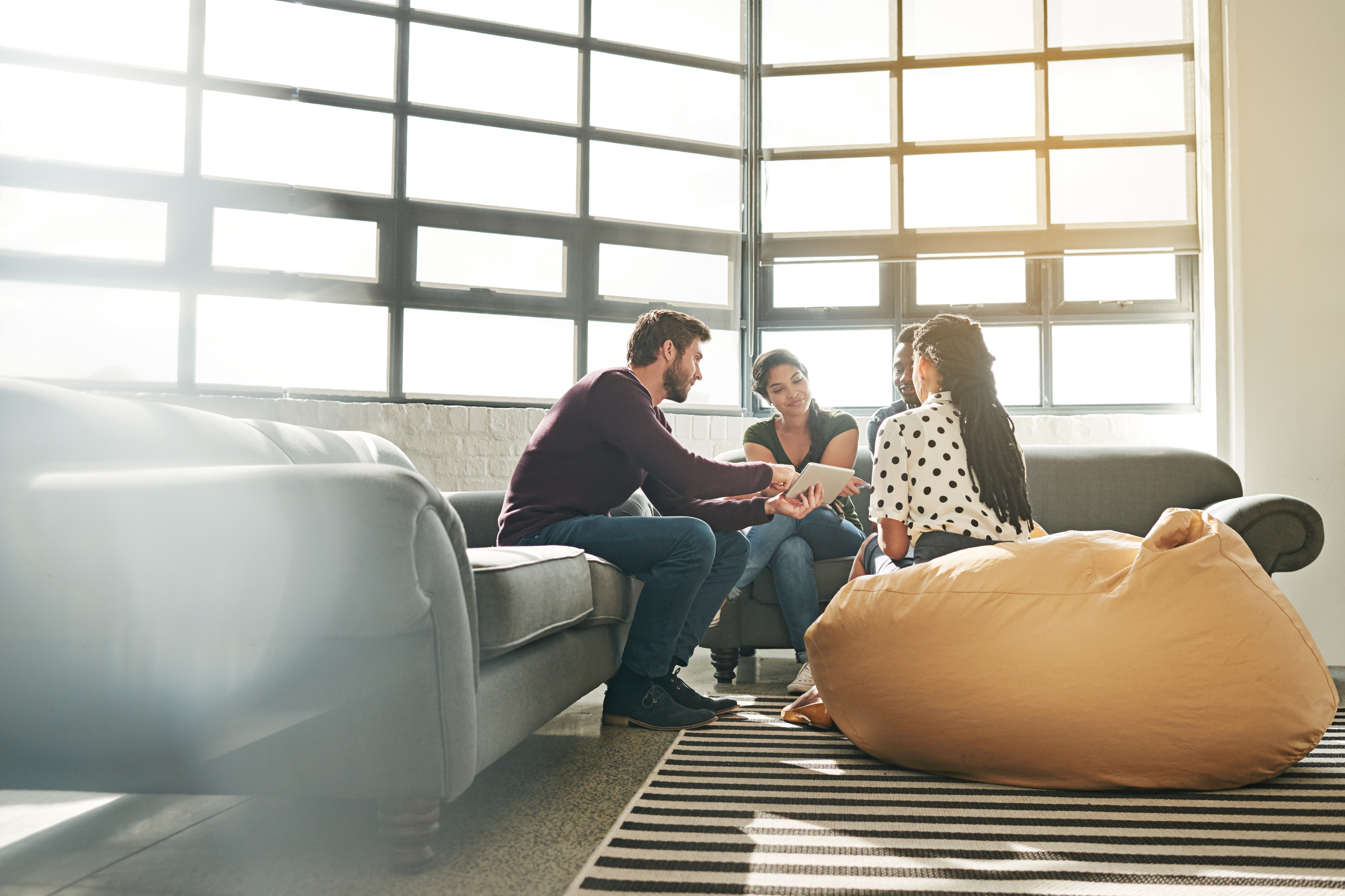 picture of 3 people sitting on a couch talking